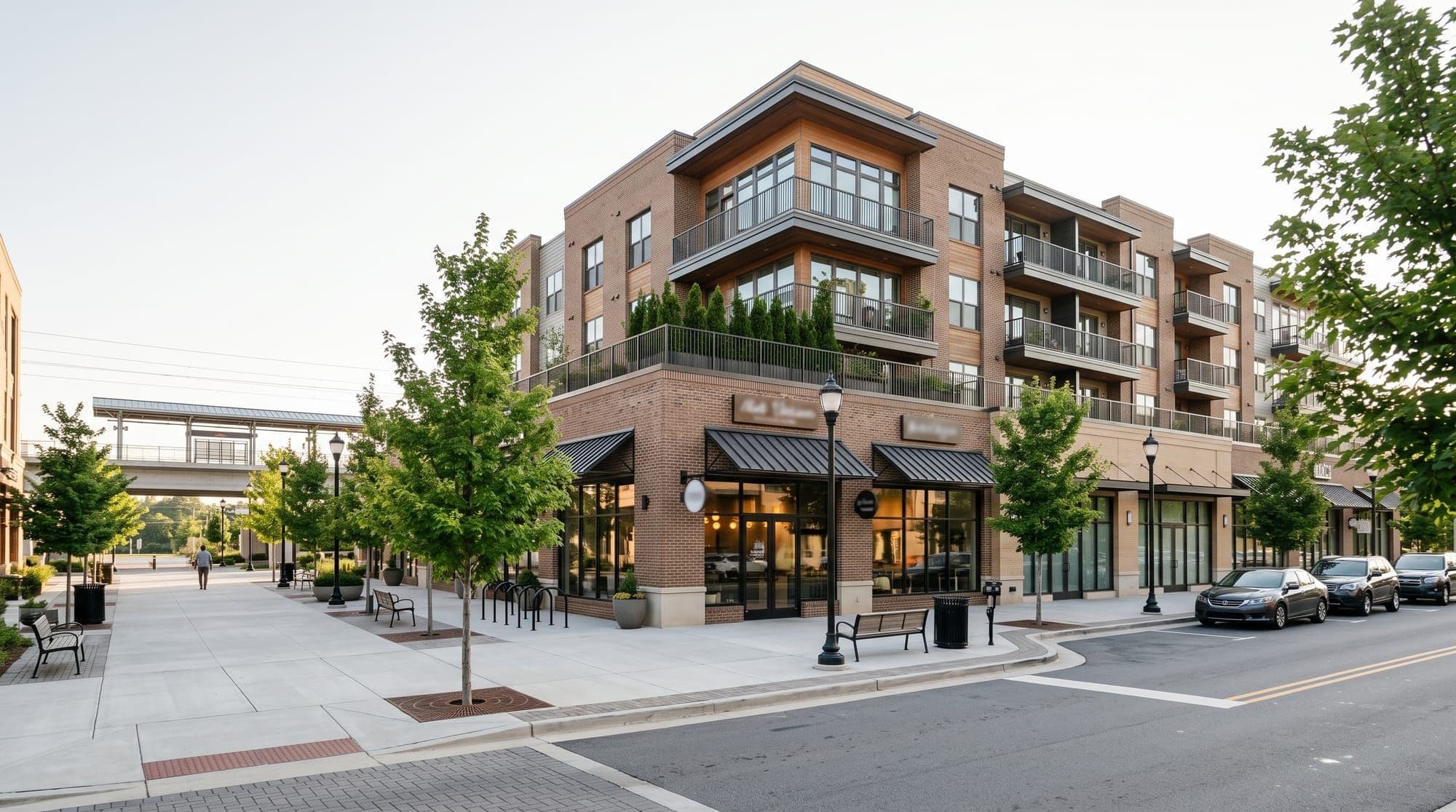 Modern mixed-use building near a transit rail platform
